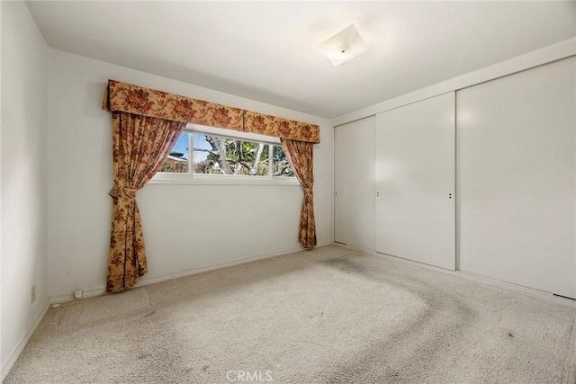 unfurnished bedroom with a closet and carpet