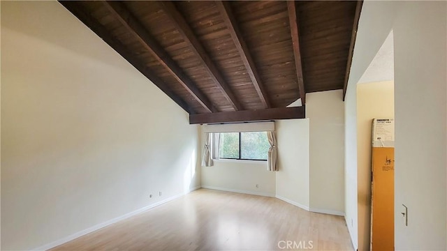 empty room featuring wooden ceiling, vaulted ceiling with beams, baseboards, and wood finished floors