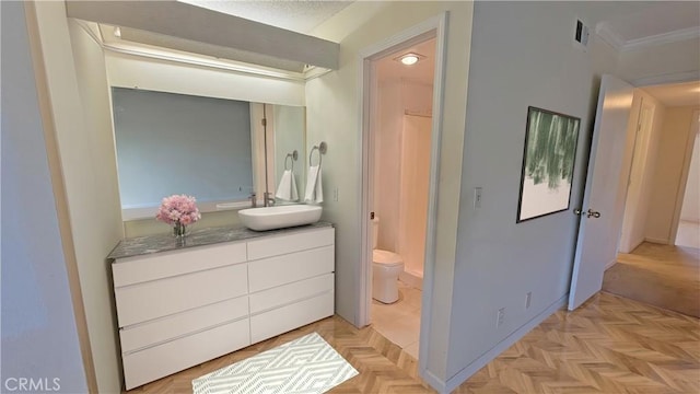 bathroom with toilet, visible vents, crown molding, and vanity