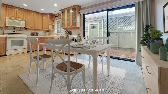 kitchen with light tile patterned floors, open shelves, light countertops, glass insert cabinets, and white appliances