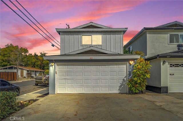 view of garage at dusk