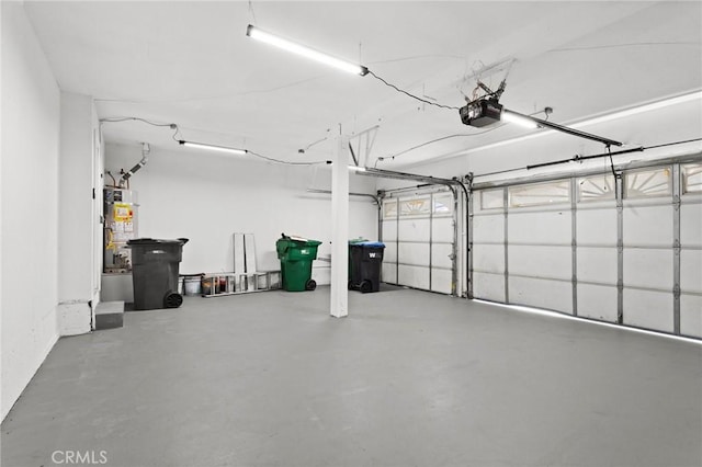 garage with a garage door opener and gas water heater