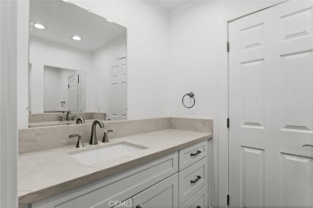 bathroom with recessed lighting and vanity