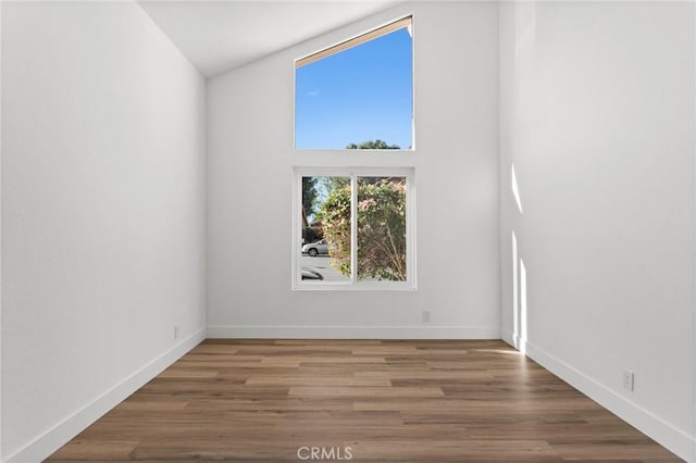 empty room featuring baseboards and wood finished floors
