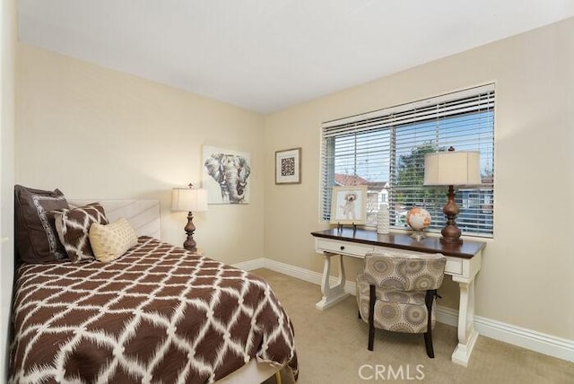 bedroom featuring carpet floors and baseboards