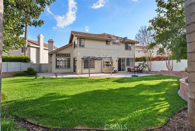 rear view of property with a patio area, a lawn, and a fenced backyard