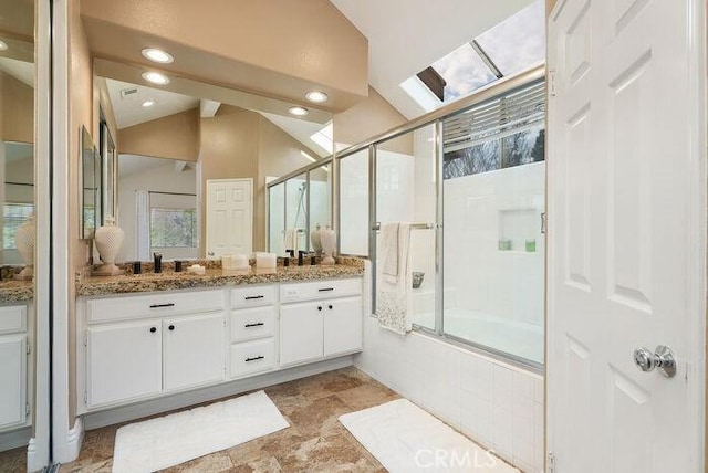 bathroom with lofted ceiling, shower / bath combination with glass door, vanity, and recessed lighting