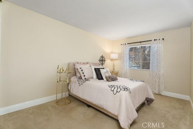 carpeted bedroom with baseboards