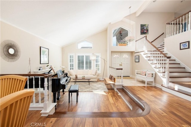 interior space featuring high vaulted ceiling, wood finished floors, baseboards, stairs, and beamed ceiling