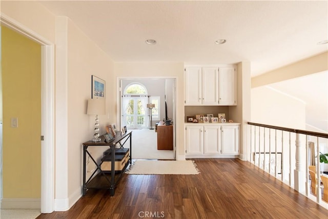 interior space featuring baseboards, dark wood-style flooring, and recessed lighting