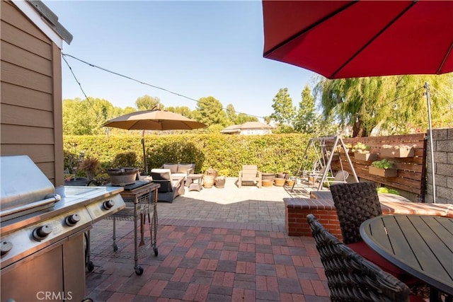 view of patio featuring fence and grilling area