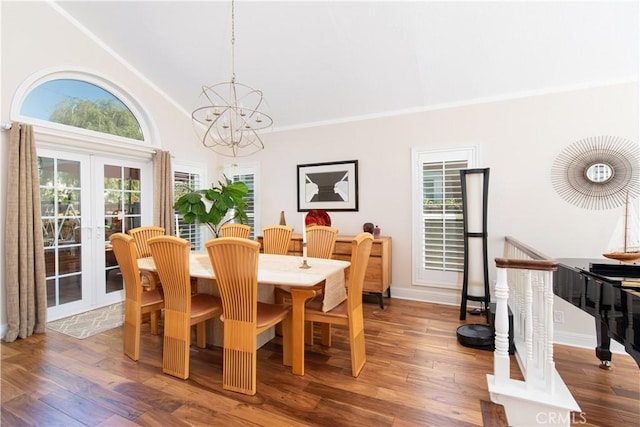 dining space featuring a chandelier, french doors, and wood finished floors