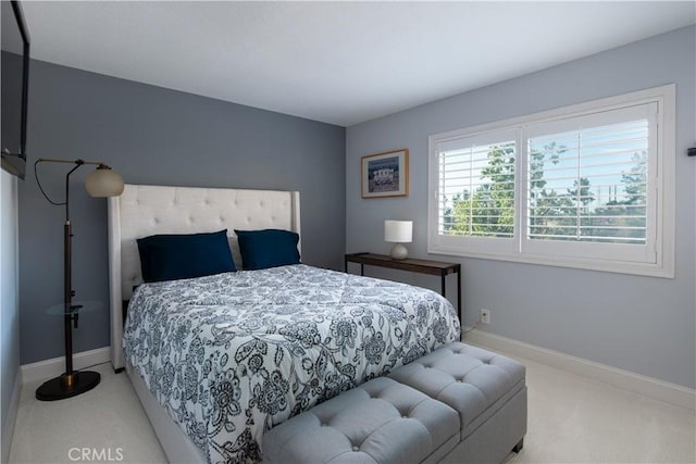 bedroom featuring carpet floors and baseboards