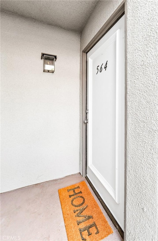 entrance to property with stucco siding