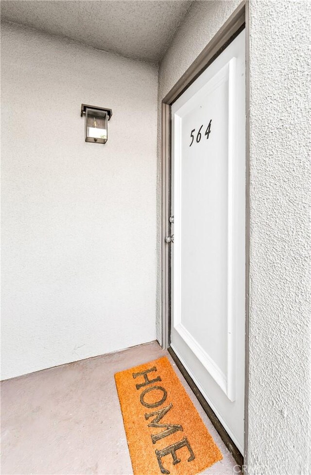 12564 Montecito Rd Unit 4, Seal Beach, CA 90740 - view of exterior entry with stucco siding