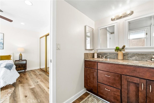 12564 Montecito Rd Unit 4, Seal Beach, CA 90740 - ensuite bathroom with double vanity, wood finished floors, and ceiling fan