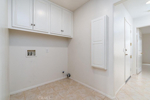 laundry area featuring baseboards, washer hookup, cabinet space, and hookup for a gas dryer