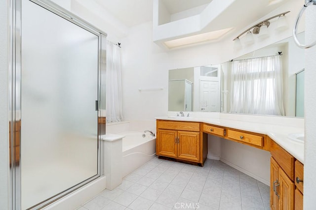 full bath featuring double vanity, a stall shower, tile patterned floors, a garden tub, and a sink