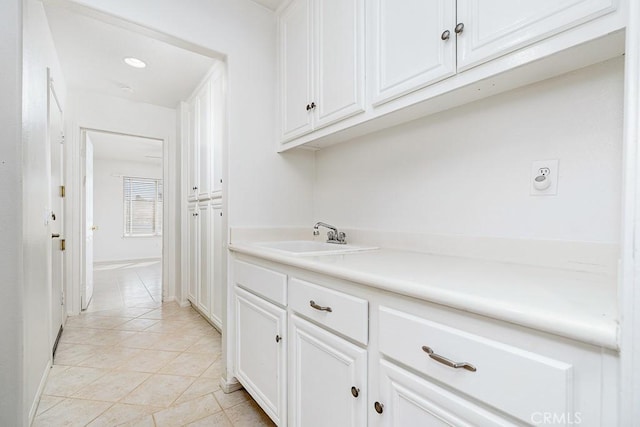 interior space with light tile patterned floors and a sink