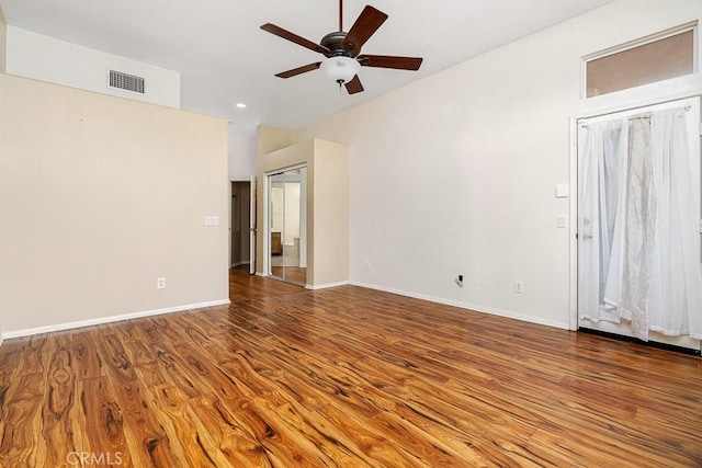 spare room with recessed lighting, visible vents, a ceiling fan, wood finished floors, and baseboards