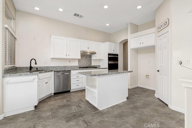 kitchen featuring visible vents, appliances with stainless steel finishes, white cabinets, a sink, and under cabinet range hood