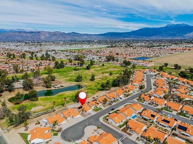 birds eye view of property with view of golf course, a water and mountain view, and a residential view