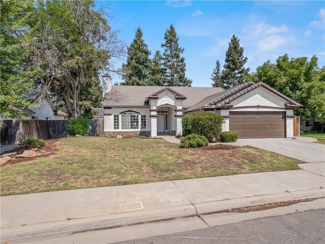 single story home with a garage, fence, driveway, stucco siding, and a front lawn