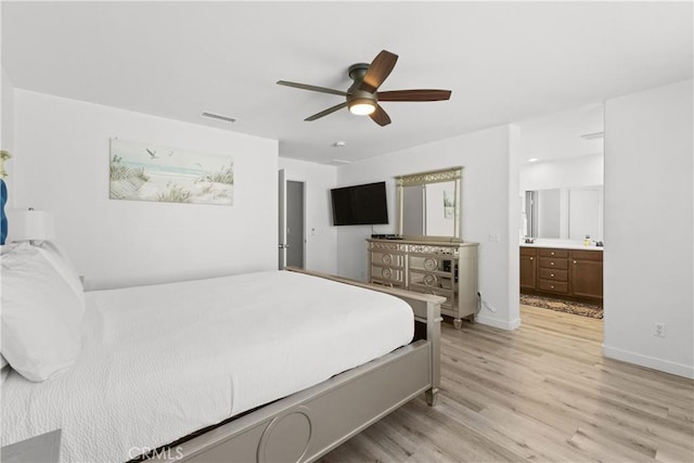 bedroom with visible vents, light wood-style flooring, connected bathroom, ceiling fan, and baseboards