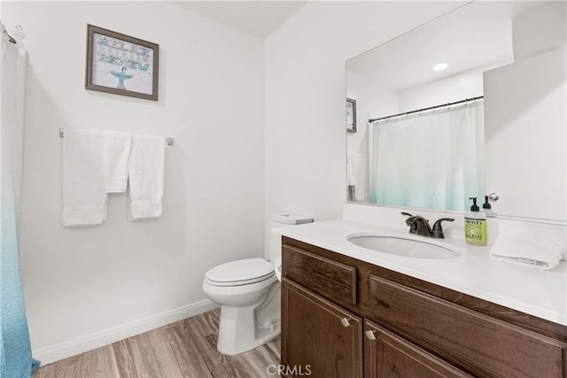 bathroom featuring toilet, vanity, wood finished floors, a shower with curtain, and baseboards