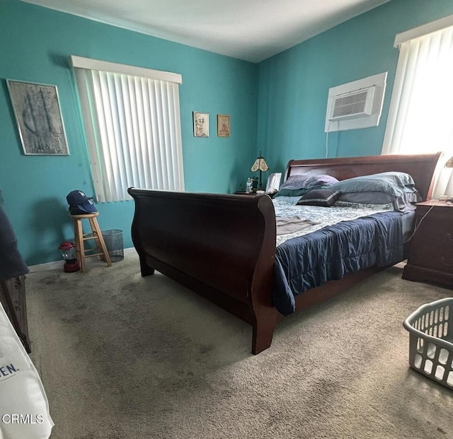 carpeted bedroom with a wall unit AC