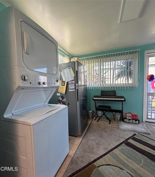 laundry area featuring stacked washer and dryer and laundry area