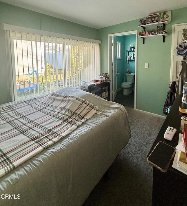 bedroom featuring connected bathroom and carpet flooring