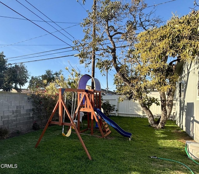 view of playground with a fenced backyard and a yard