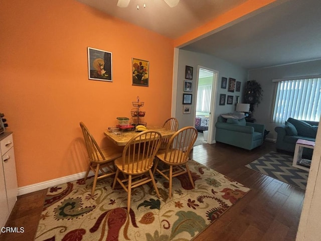 dining room with ceiling fan, baseboards, and hardwood / wood-style flooring