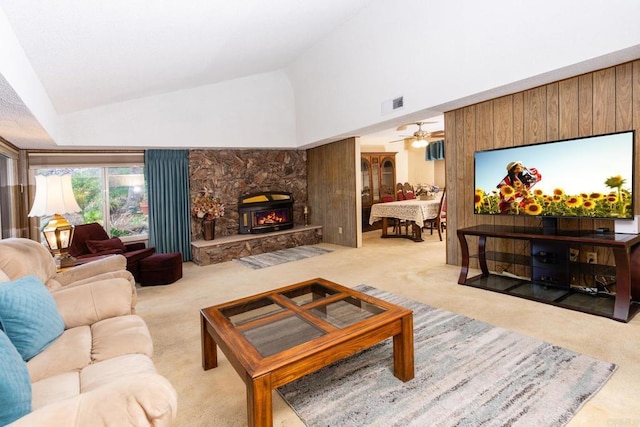 carpeted living area with high vaulted ceiling, a fireplace, and visible vents