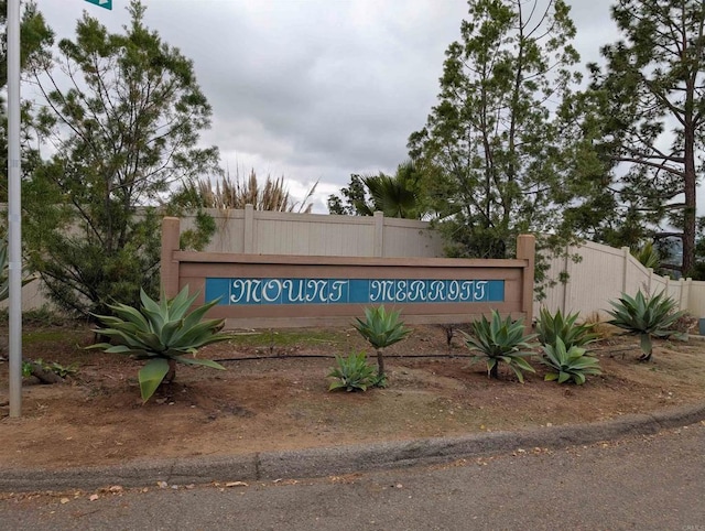 community / neighborhood sign with fence