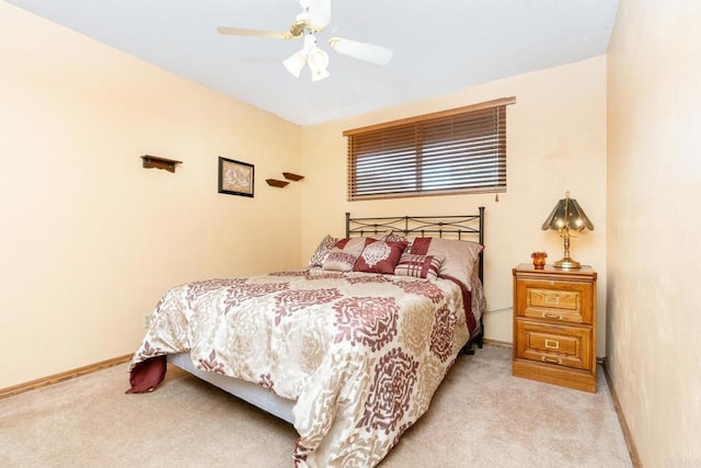 bedroom featuring light carpet, ceiling fan, and baseboards