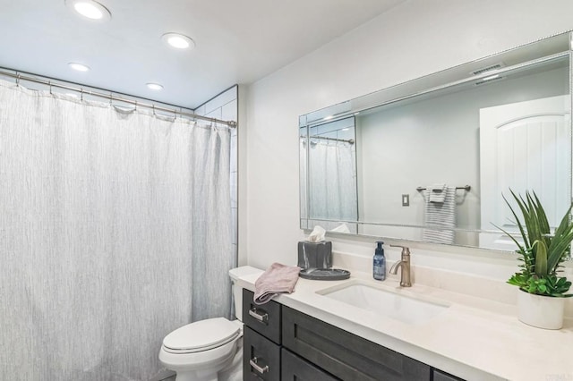 full bathroom with recessed lighting, vanity, and toilet