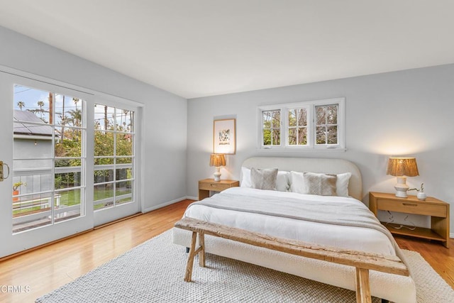 bedroom with baseboards and wood finished floors