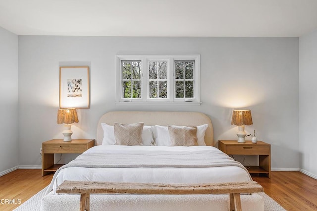 bedroom featuring light wood-type flooring and baseboards