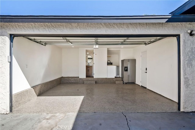 garage with stainless steel fridge