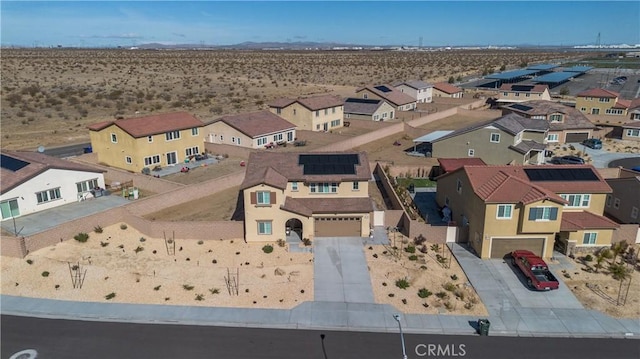 birds eye view of property featuring a residential view and a desert view