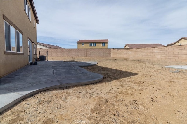 view of yard with central air condition unit, a patio, and a fenced backyard