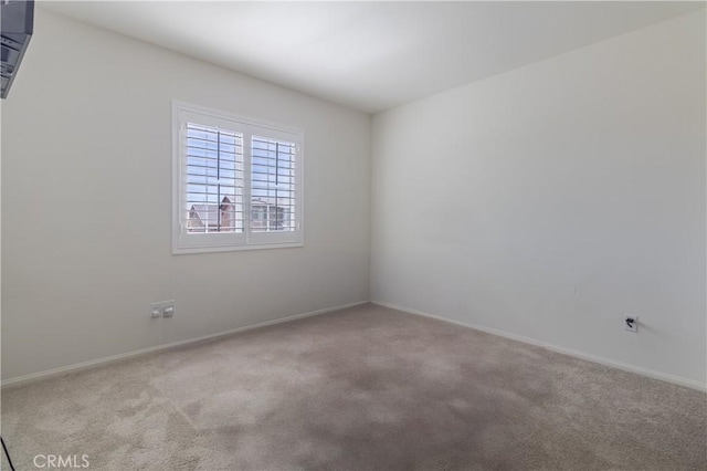 empty room with baseboards and carpet