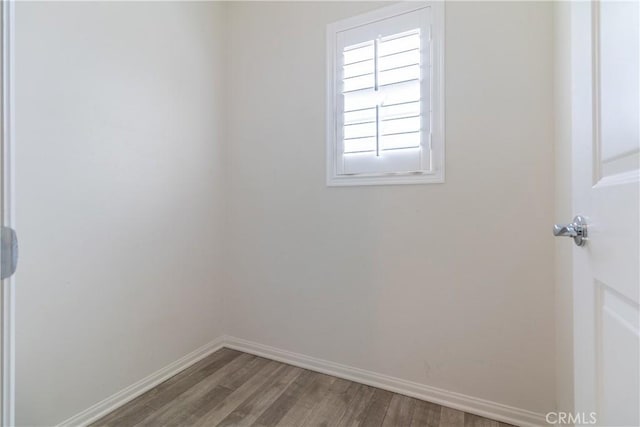 empty room with wood finished floors and baseboards