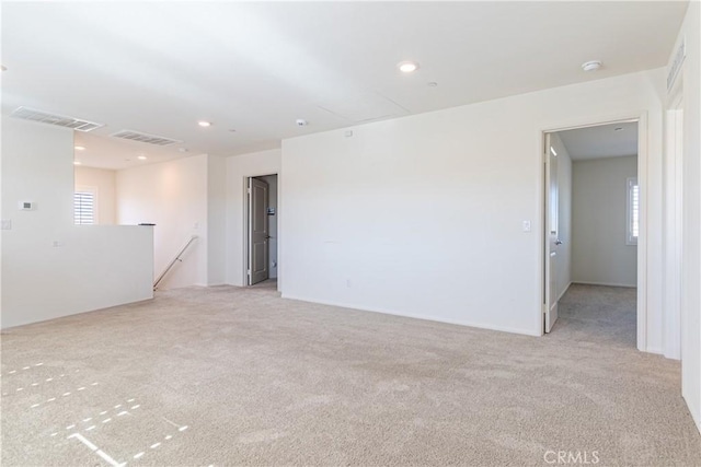 spare room featuring recessed lighting, visible vents, and light colored carpet