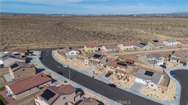 bird's eye view with a mountain view, a residential view, and view of desert