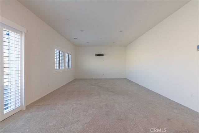 unfurnished room featuring light colored carpet