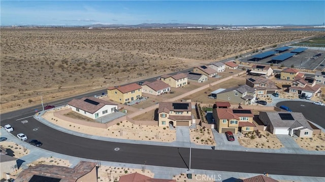 drone / aerial view with a mountain view, a residential view, and a desert view