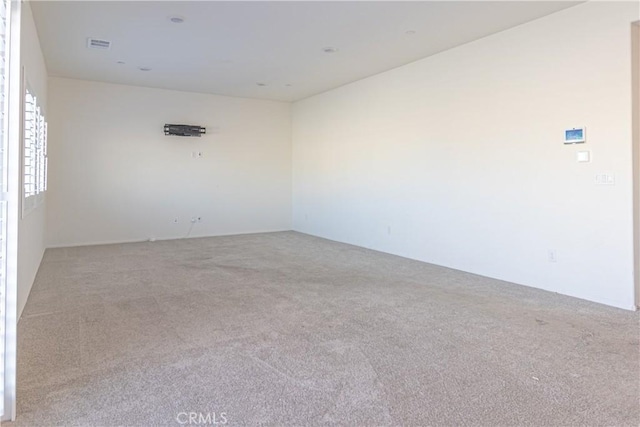 spare room with visible vents and carpet flooring